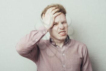 A young man having a headache