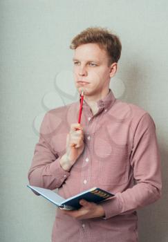 man planning calendar with a notebook and pencil