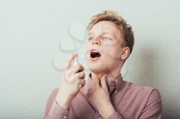young guy using Inhaler