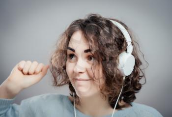 Young beautiful woman listening to music with headphones