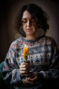 girl holding a candlestick with a candle