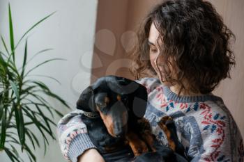 girl with dog dachshund in her arms