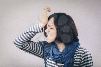 upset young woman with hand on his head