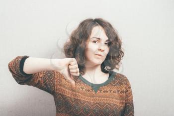 woman showing thumbs down