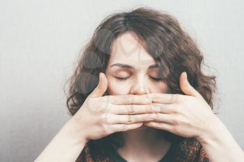 woman covers her mouth