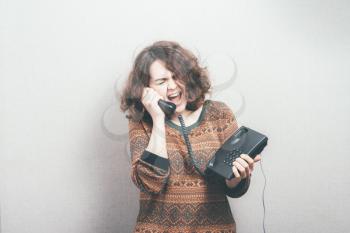 woman yells in landline phone