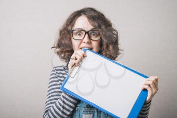 Girl with glasses biting teeth in the book cover
