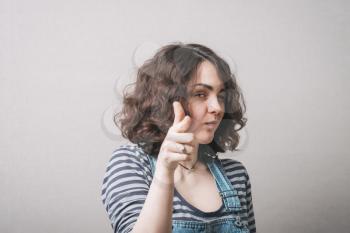 A woman shows a finger forward