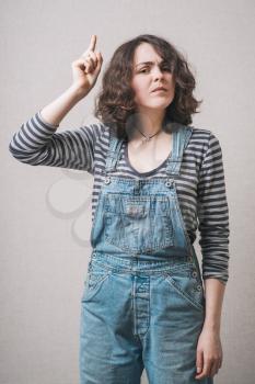 a woman has an idea, dressed in overalls