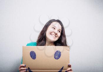 girl holding cardboard with a happy smiley