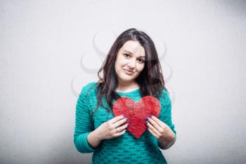 girl holding a toy heart