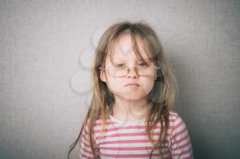Portrait of happy girl wearing glasses against eye
