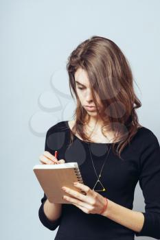 woman writes in a notebook