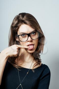 young woman with finger on tongue