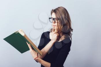 Woman with big book. On a gray background.
