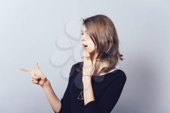 a woman shows the index finger forward profile