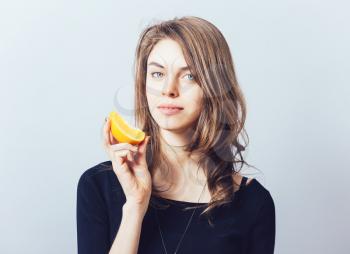 young beautiful woman with citrus orange fruit having fun. 