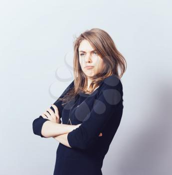 Young businesswoman is standing and folding her arms on her chest.