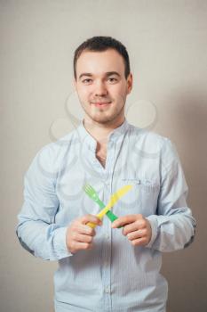 Young happy man holding a fork and a knife 