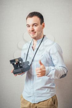 Handsome young man with retro photo camera 
