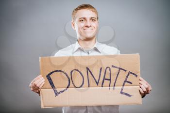 man holding Cardboard text a donate