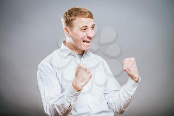 Excited corporate guy clenching his fists