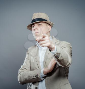 businessman in formal wear and a hat pushing forefinger screen 