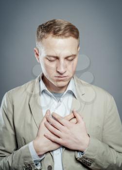 Both man's hands on breast because of hard breathing
