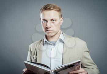 Business man reading a book over isolated background