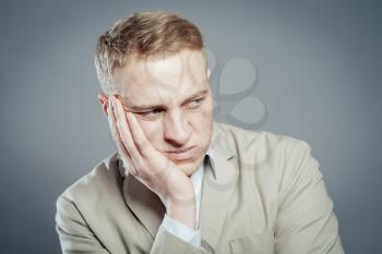 young businessman in agony with a toothache 