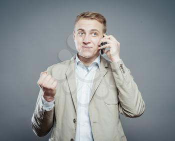 young business man conversation over the cellphone, fist holding