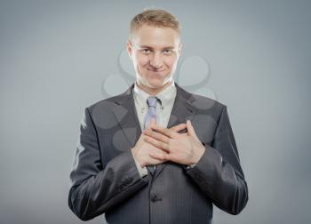 Businessman with hands on  his chest. smile