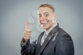 Happy businessman thumbs up sign