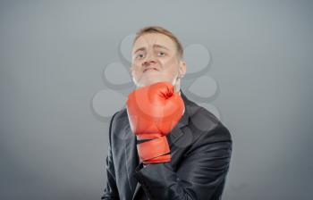 businessman in boxing gloves cause to fight, shows that hit isolated 