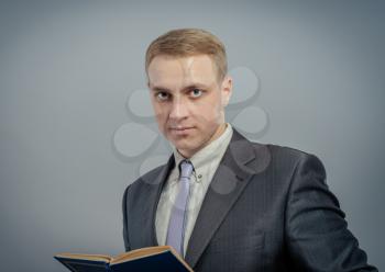 Young man holding book isolated 