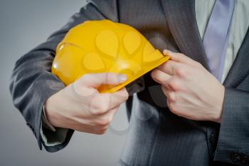 engineer or worker hand holding yellow helmet
