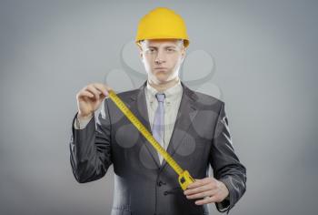 young builder with yellow tape measure