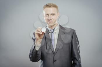 The doctor in a white lab coat holding a stethoscope