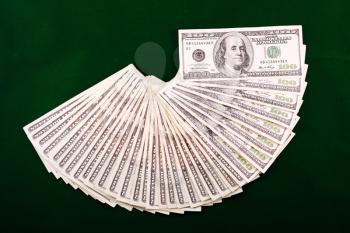 A combination of dollar fan over a green background
