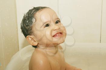 litlle baby bathes in a bathroom