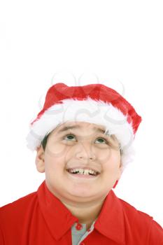 Head shot of young beauty Santa boy looking up to copy space and smiling 
