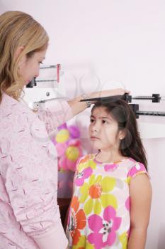 Doctor measure little child girl height growth 