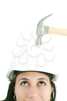 girl with safety helmet about to be hit by a hammer over a white background 
