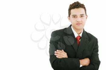 Young business man standing against the wall with crossed arms 
