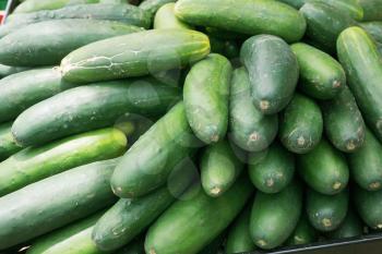 cucumbers bunched together for sale at market good as a background 