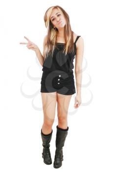 slim young female in black short and boots show victory sign over white background 