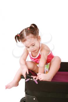little girl in a suitcase, isolated on a white background 
