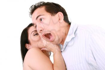 woman tells something into surprised guy's ear isolated on white background