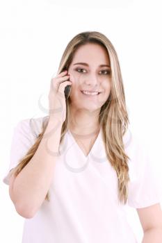 Young beautiful woman-nurse talks by mobile phone, isolated on white background. 
