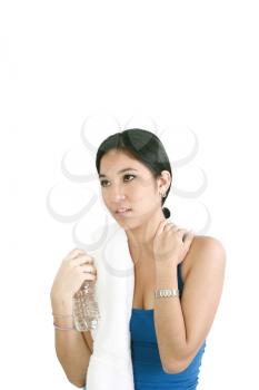 Portrait of young happy smiling woman in sportswear holding bottle of water, isolated on white background 